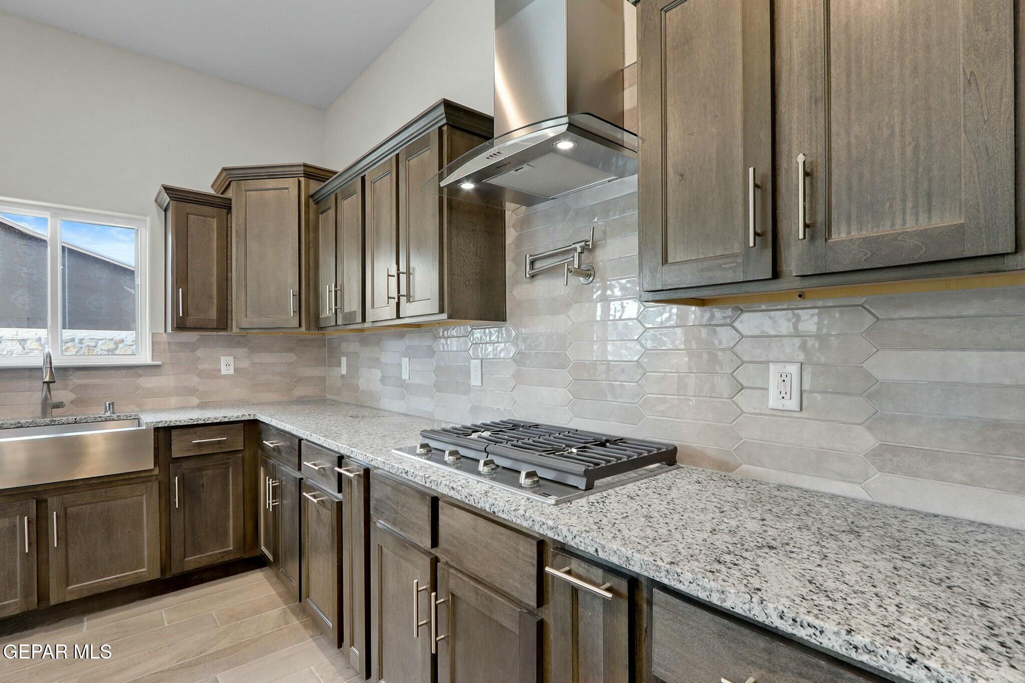 3872 Object Place El Paso, TX 79938 - Photo 8 of 33 a kitchen with stainless steel appliances granite countertop a sink stove and cabinets