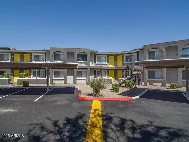 a front view of a building with sitting area