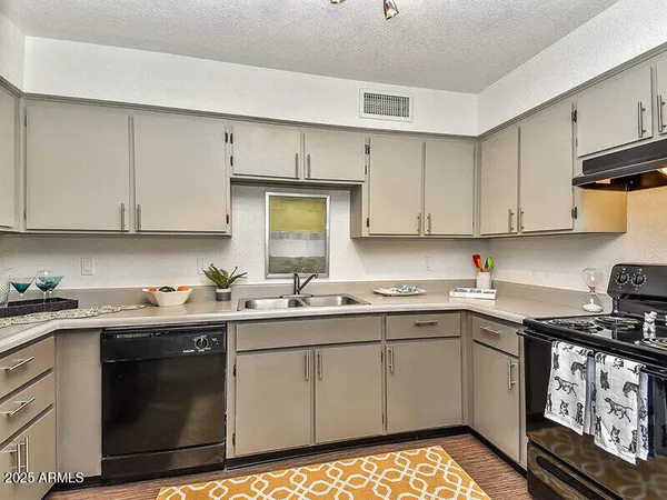 a kitchen with a sink stove top oven and cabinets