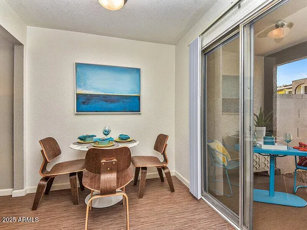 a dining room with furniture and wooden floor