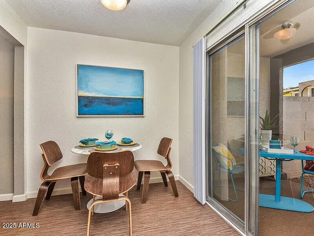 a dining room with furniture and wooden floor