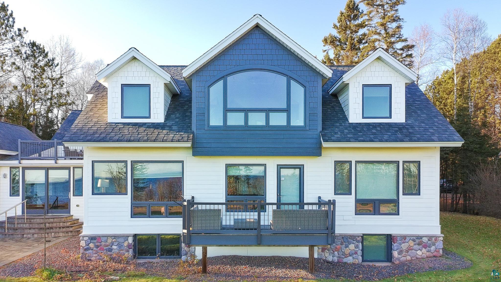5163 Greenwood Road Duluth, MN 55804 - Photo 44 of 47 Two-story residence featuring white horizontal siding, a dark shingle roof, and stone facade accents