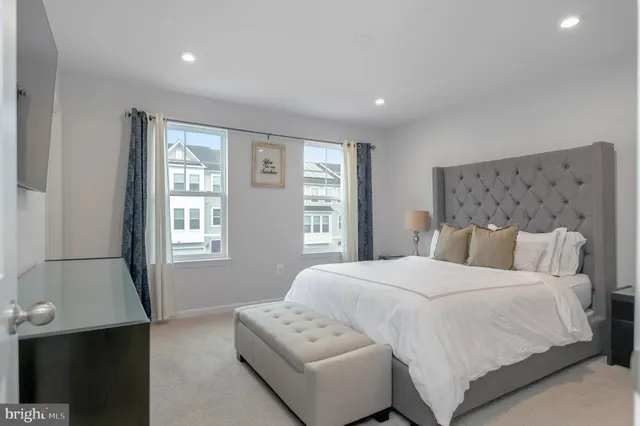 a bedroom with a large bed and a window