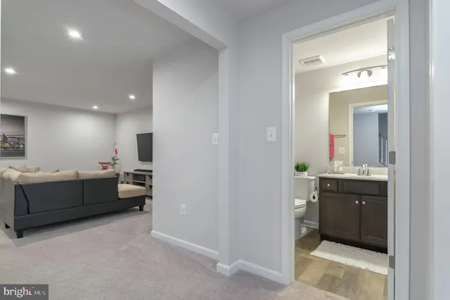 a large bathroom with a double vanity sink mirror and bathtub