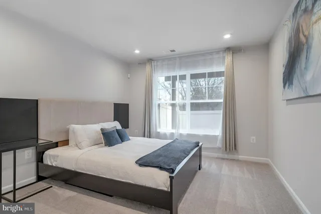 a bedroom with a large bed and a window