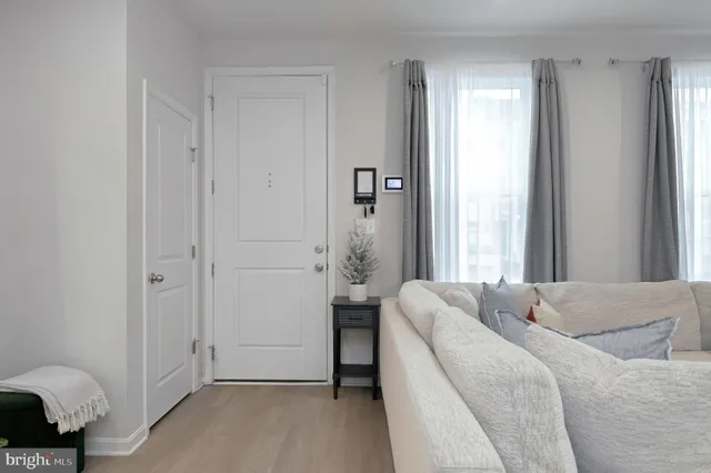 a living room with a bed furniture and a window