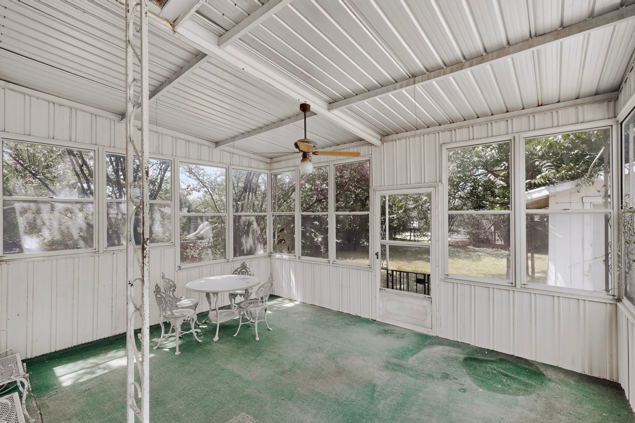 4703 Leslie Avenue Austin, TX 78721 - Photo 30 of 34 A well-lit screened patio provides an inviting outdoor living space.