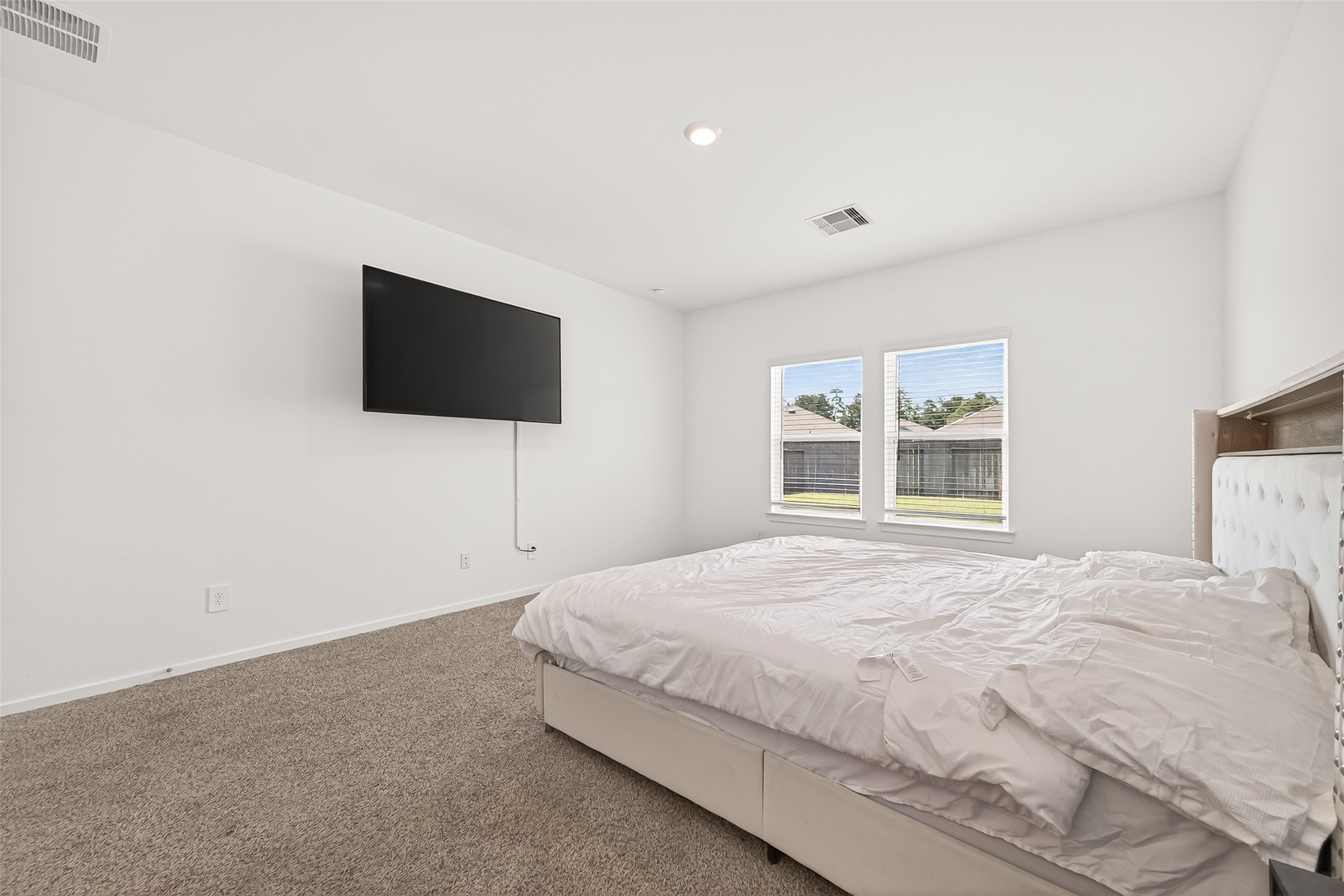 5442 Pinetree Cres Lane Spring, TX 77373 - Photo 9 of 24 Private primary suite, located downstairs, offers plenty of natural light, views of the backyard, and an en suite bath