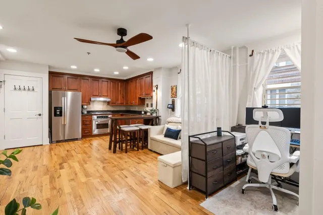 a living room with furniture and kitchen view