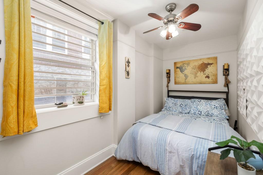 259 14th Street Northeast, Unit B103 Atlanta, GA 30309 - Photo 13 of 33 a bedroom with a large bed and a chandelier