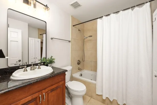 a bathroom with a sink a toilet and a mirror