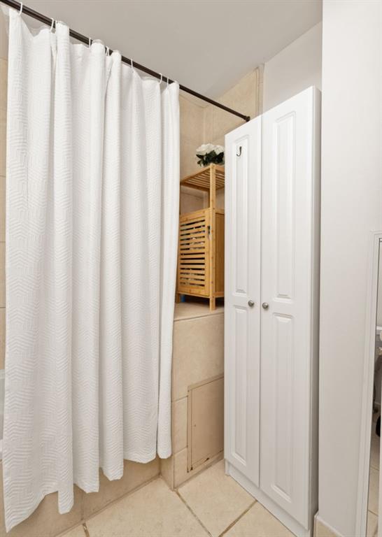 259 14th Street Northeast, Unit B103 Atlanta, GA 30309 - Photo 17 of 33 a bathroom with a shower and a tub