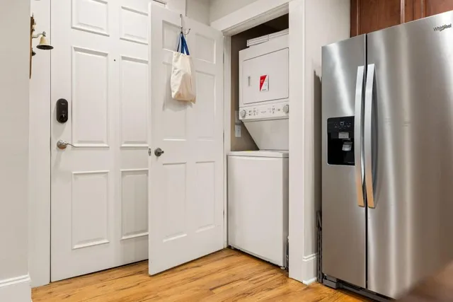 a view of kitchen with refrigerator and wooden floor