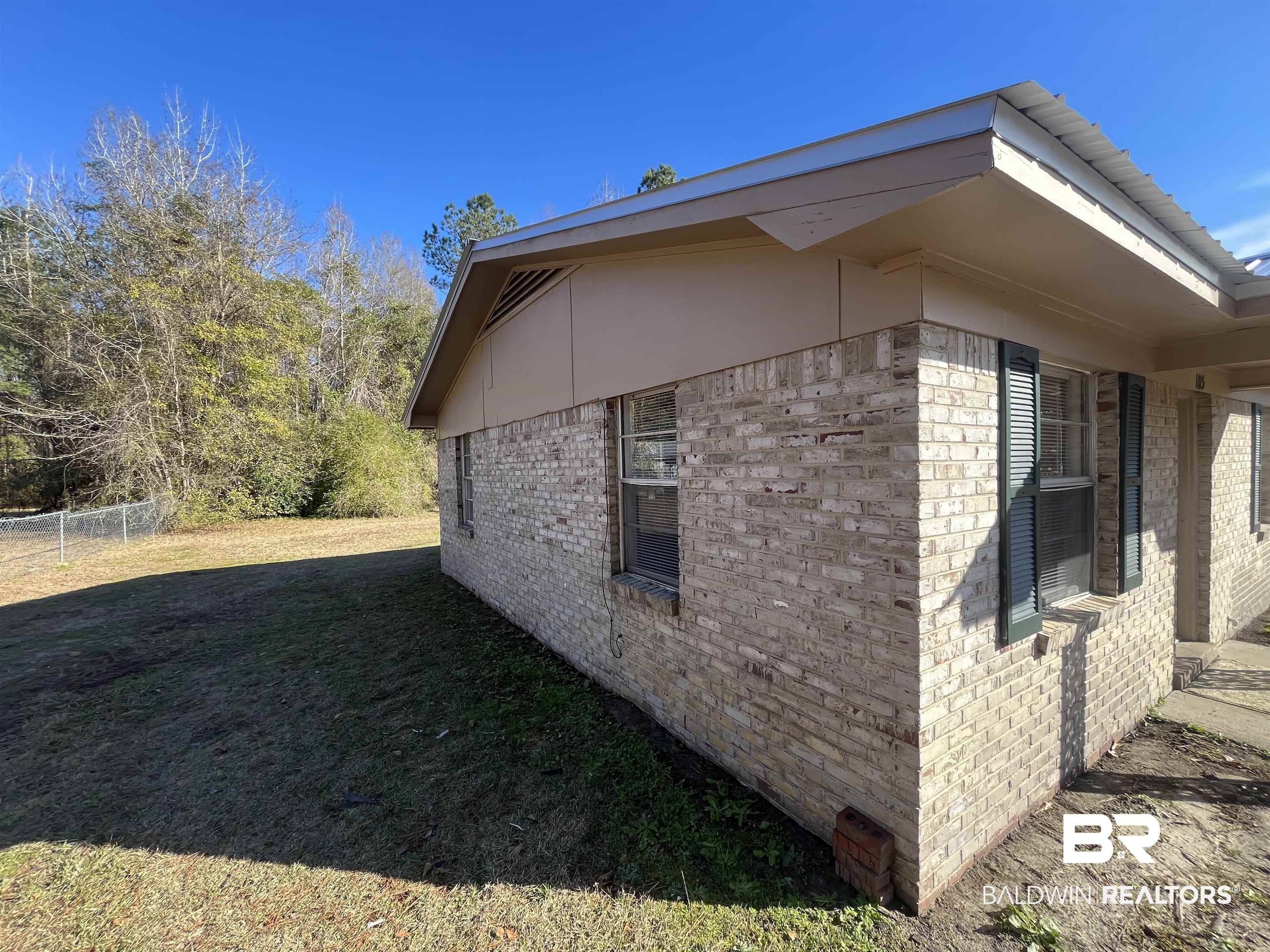 103 Roadway Street Brewton, AL 36426 - Photo 2 of 13 View of side of property featuring a yard