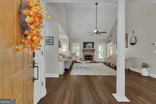 a living room with furniture a fireplace and a chandelier