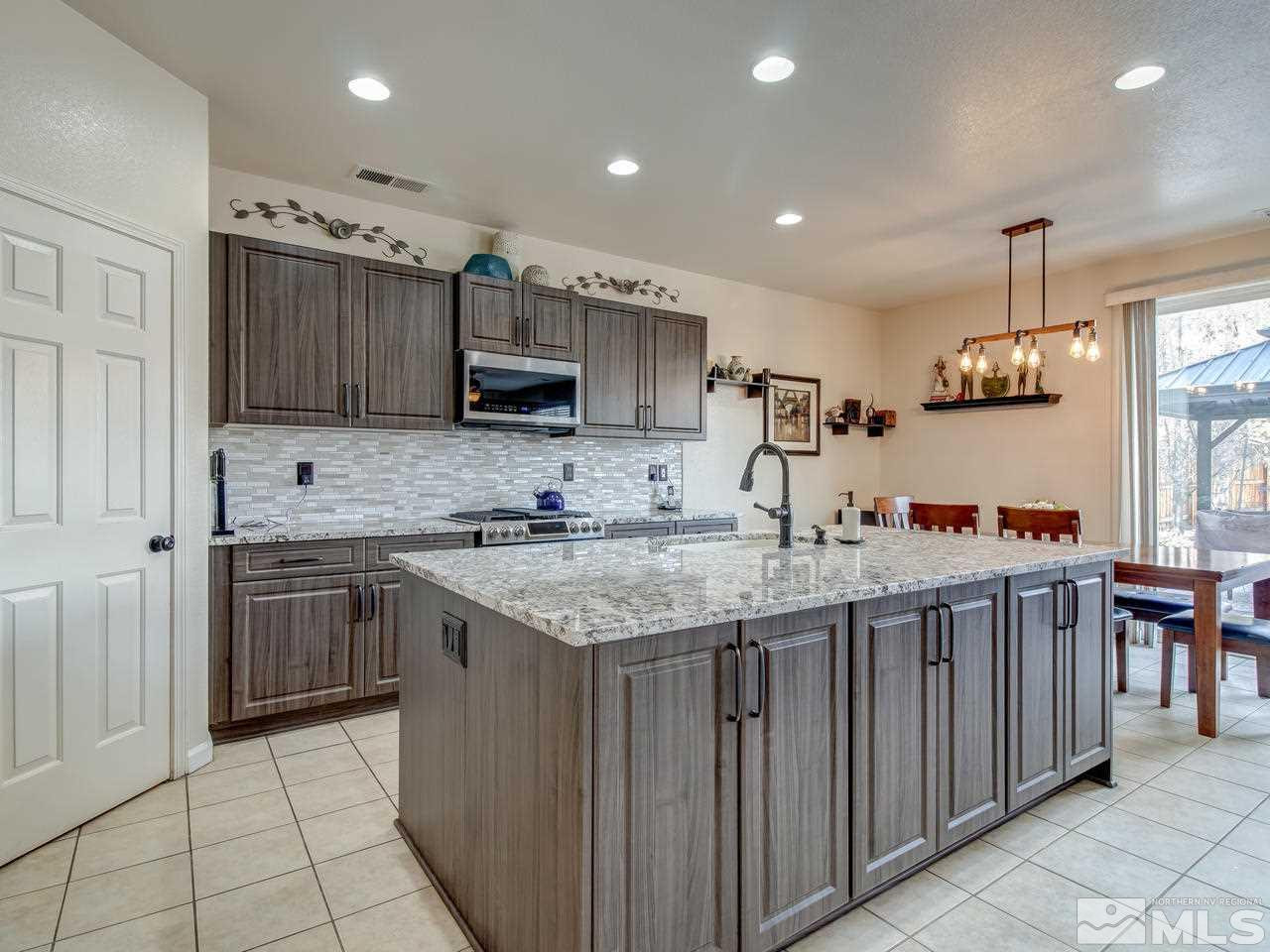 1723 Cavern Drive Reno, NV 89521 - Photo 4 of 25 a kitchen with stainless steel appliances granite countertop a sink and cabinets