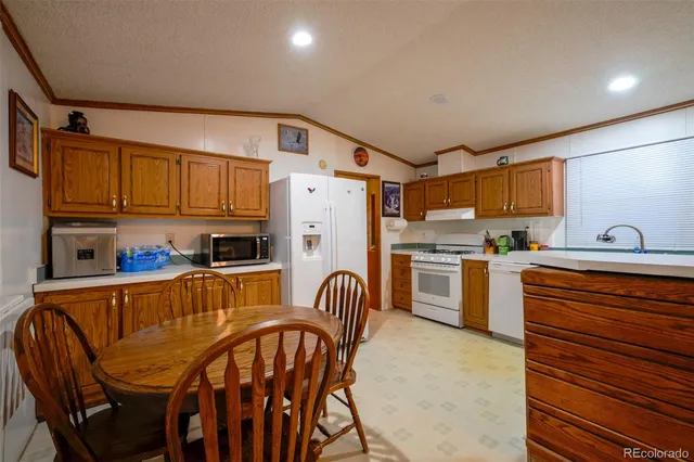a kitchen with stainless steel appliances granite countertop a refrigerator and microwave