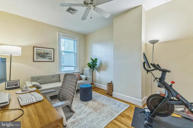 a living room with furniture a rug and a window