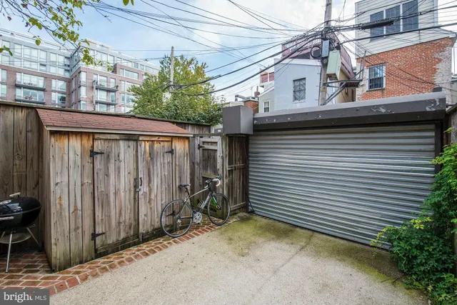 a view of a house with wooden fence