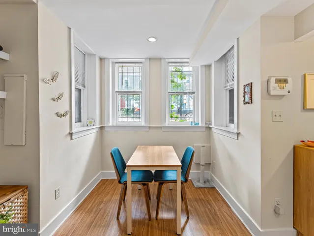 a view of a dining room with furniture and a window