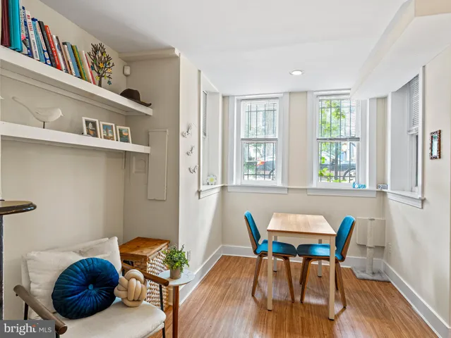 a view of a dining room with furniture a rug and wooden floor