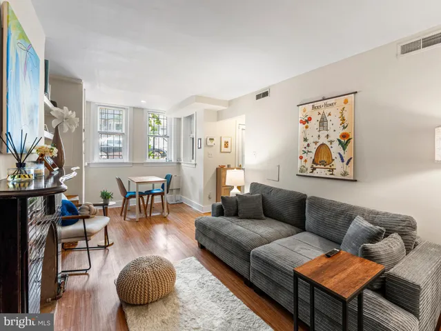 a living room with furniture a rug and a large window