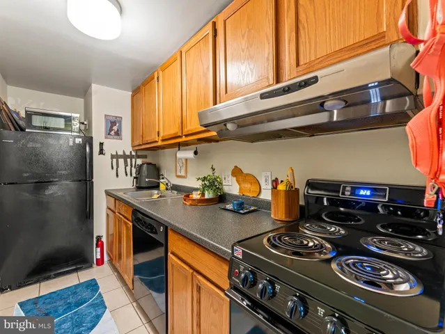 a kitchen with stainless steel appliances granite countertop a stove and a refrigerator