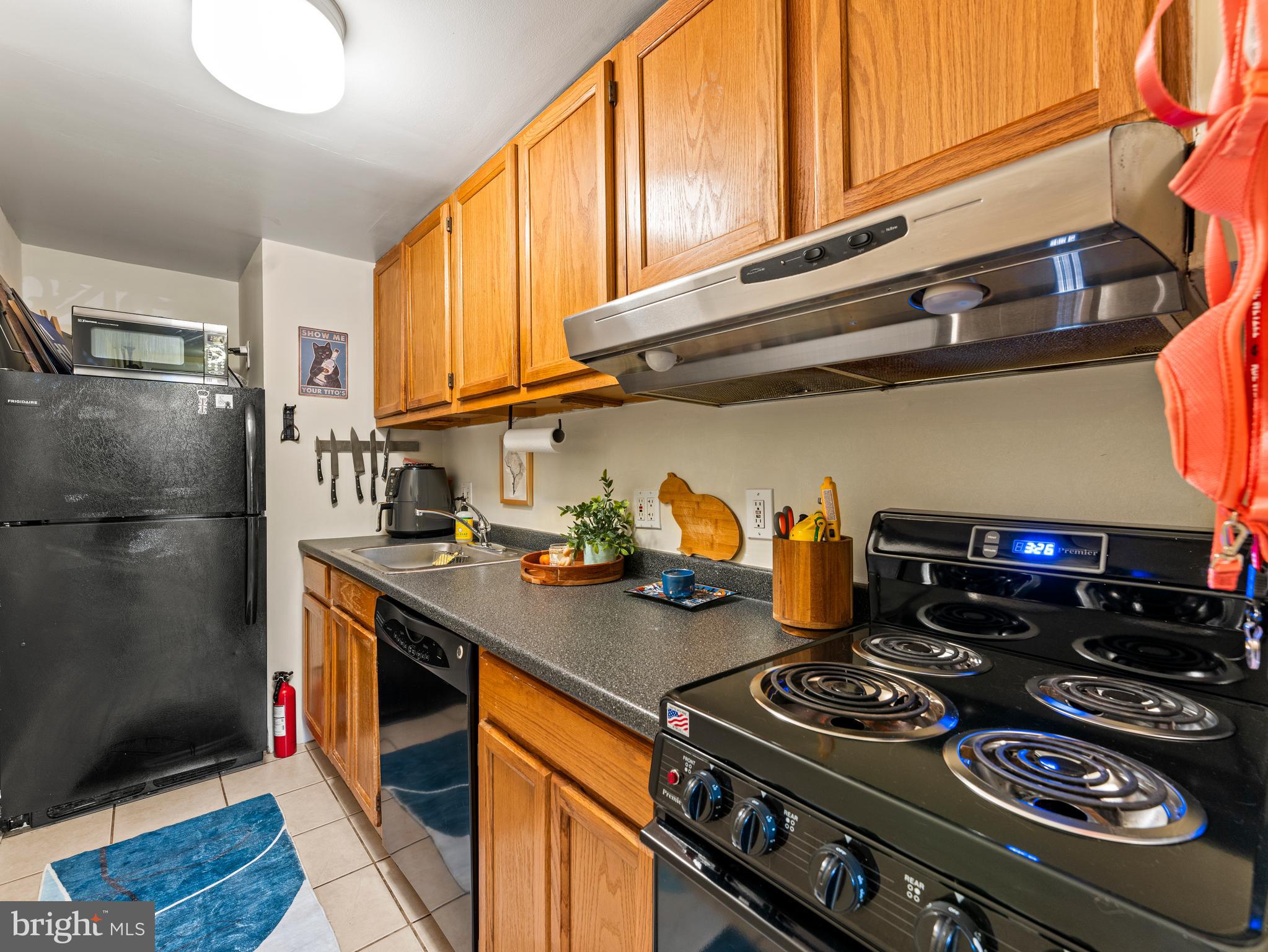 1414 Swann Street Northwest Washington, DC 20009 - Photo 29 of 38 a kitchen with stainless steel appliances granite countertop a stove and a refrigerator