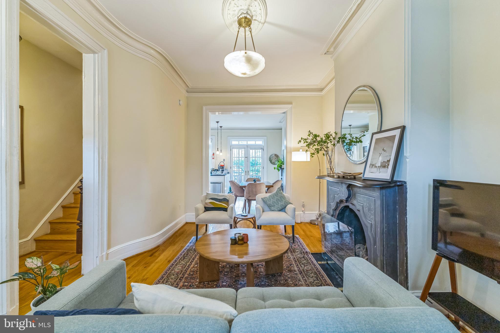 1414 Swann Street Northwest Washington, DC 20009 - Photo 5 of 38 a living room with furniture a flat screen tv and a window