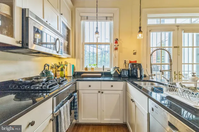 a kitchen with stainless steel appliances granite countertop a stove and a sink