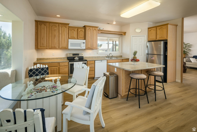 684 Blue Mountain Ridge Monticello, UT 84535 - Photo 37 of 71 Kitchen with stainless steel appliances, a kitchen bar, a kitchen island, light wood finished floors, and recessed lighting