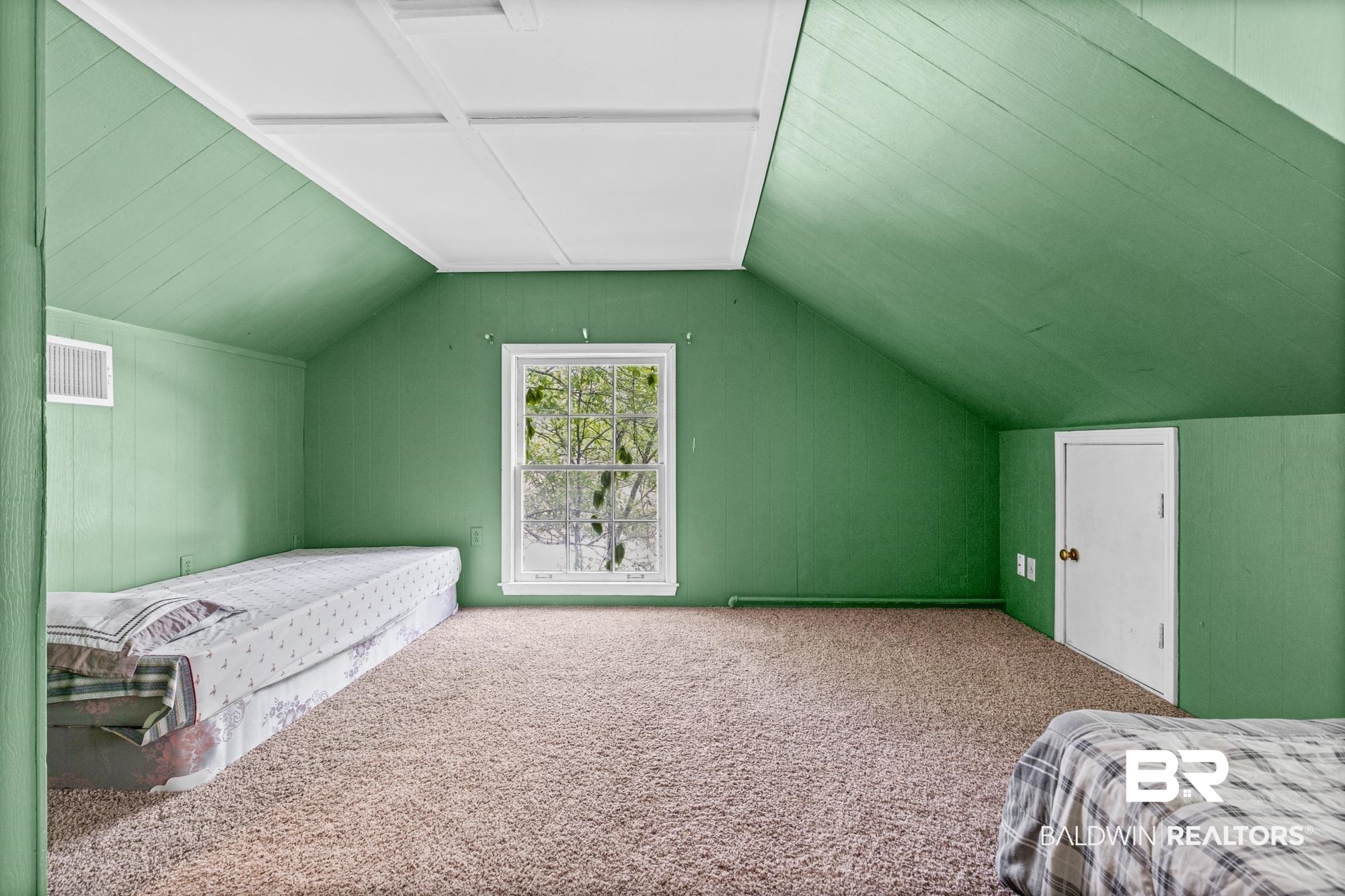 5510 Richmond Road Mobile, AL 36608 - Photo 16 of 21 Carpeted room featuring a white-framed window, angled ceilings, and a paneled accent wall