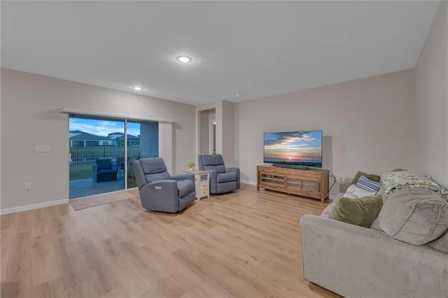 a living room kitchen with furniture and a table