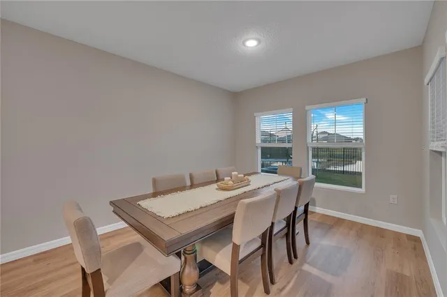 a view of a dining room with furniture window and wooden floor