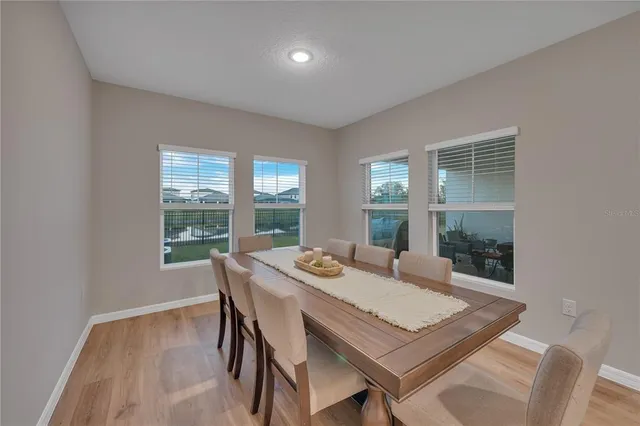 a large white kitchen with a table and chairs in it