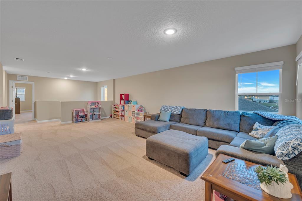 12710 Hysmith Loop Parrish, FL 34219 - Photo 22 of 45 a living room with furniture and a flat screen tv