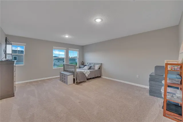 a view of a hallway with workspace and a window