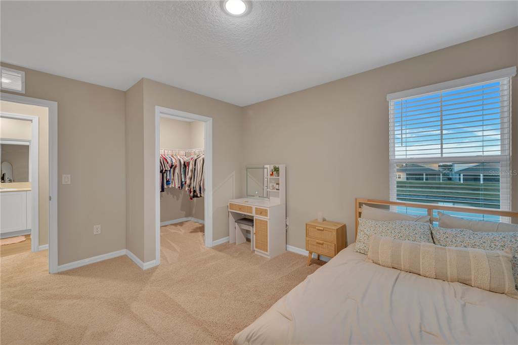 12710 Hysmith Loop Parrish, FL 34219 - Photo 27 of 45 a bedroom with a bed and a large window