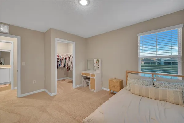 a view of walk in closet with clothes