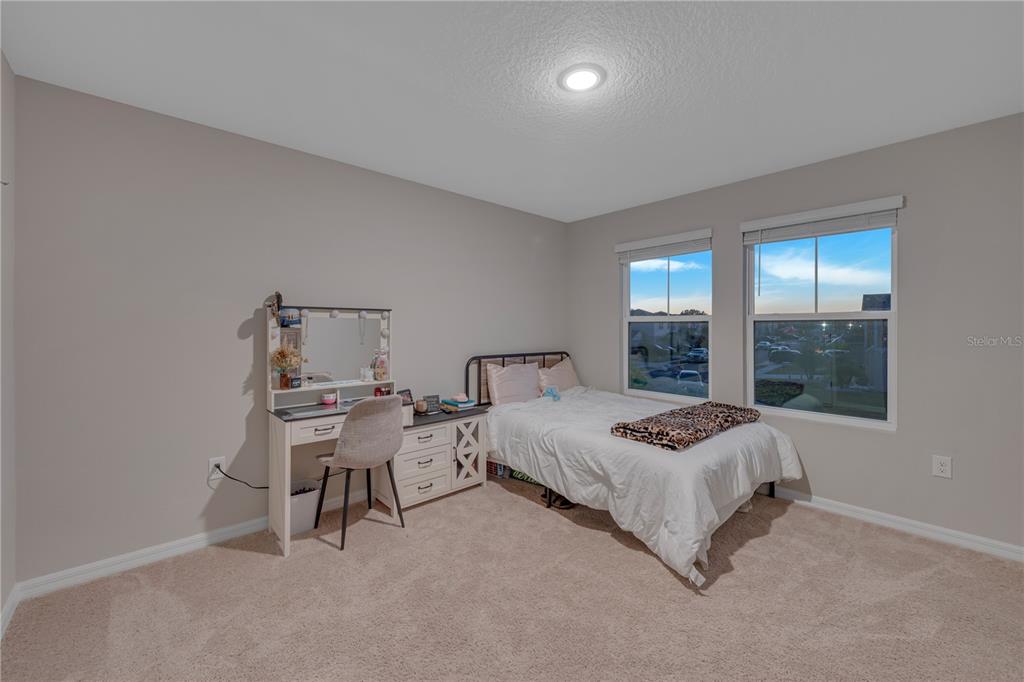 12710 Hysmith Loop Parrish, FL 34219 - Photo 36 of 45 a bedroom with a bed and window