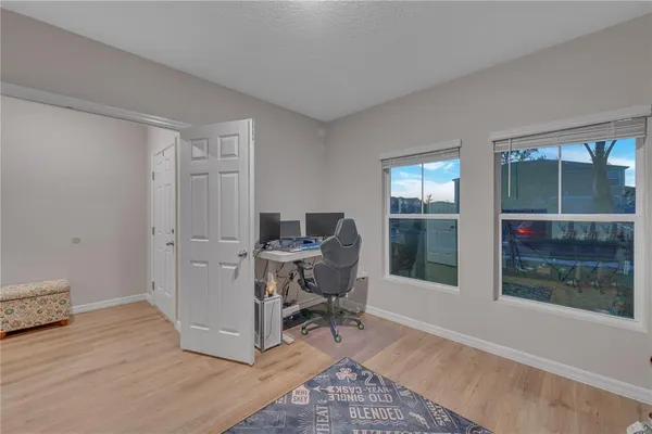 a room with lots of books and a large window
