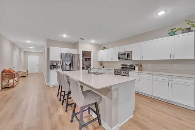 a kitchen with a table and chairs in it