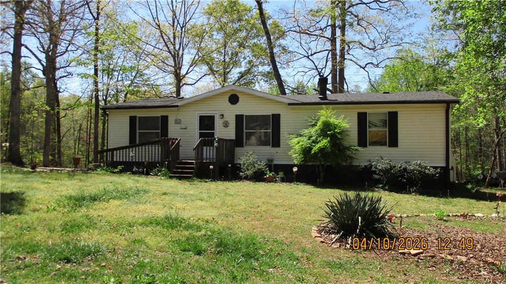 5507 Hemlock Court Lula, GA 30554 - Photo 1 of 8 a front view of house with yard and green space