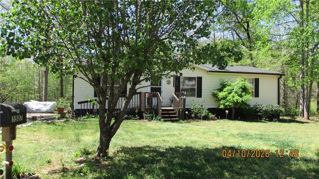 5507 Hemlock Court Lula, GA 30554 - Photo 3 of 8 a view of a house with backyard and sitting area