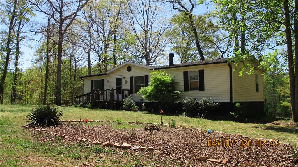 5507 Hemlock Court Lula, GA 30554 - Photo 4 of 8 a front view of a house with a yard and tree s