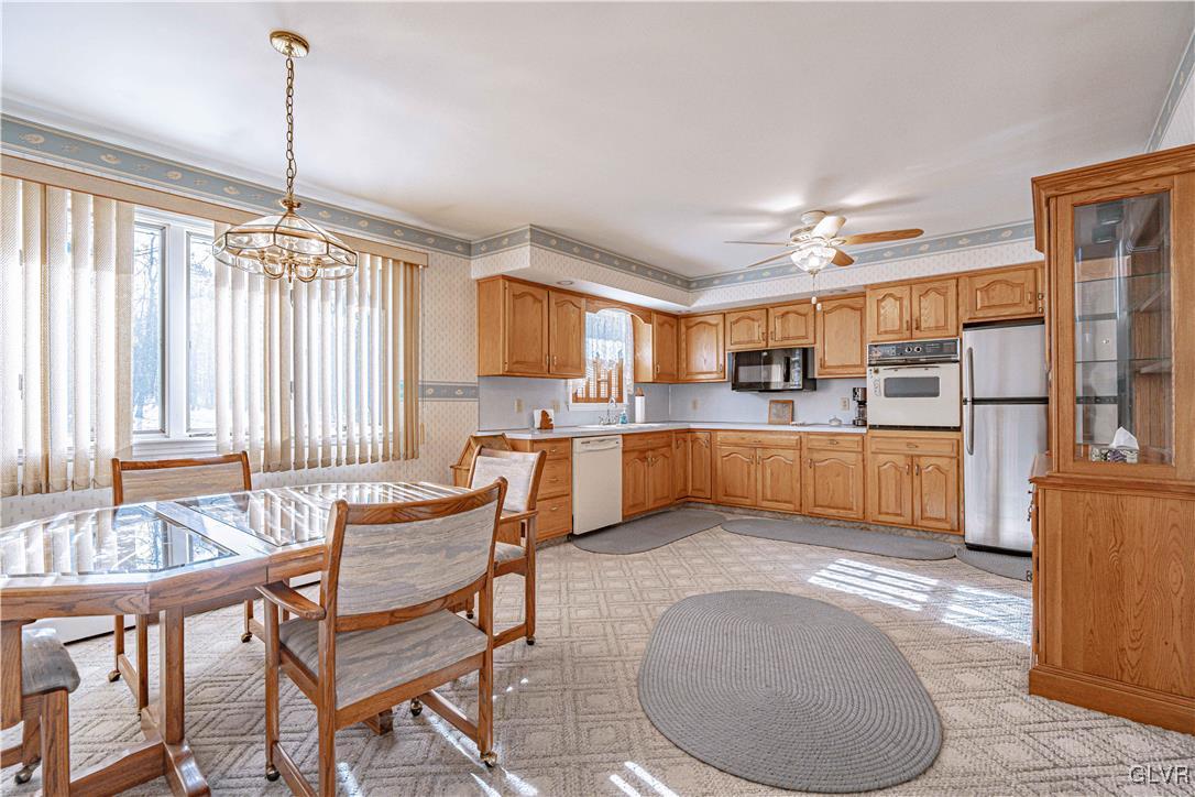 551 Birch Road Hazleton, PA 18202 - Photo 11 of 44 a large kitchen with a table chairs and a chandelier