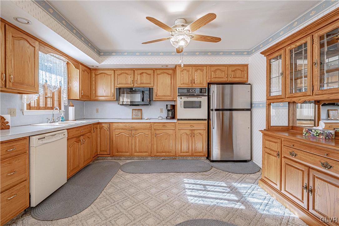 551 Birch Road Hazleton, PA 18202 - Photo 12 of 44 a kitchen with stainless steel appliances granite countertop a refrigerator a stove a sink dishwasher and wooden cabinets with wooden floor
