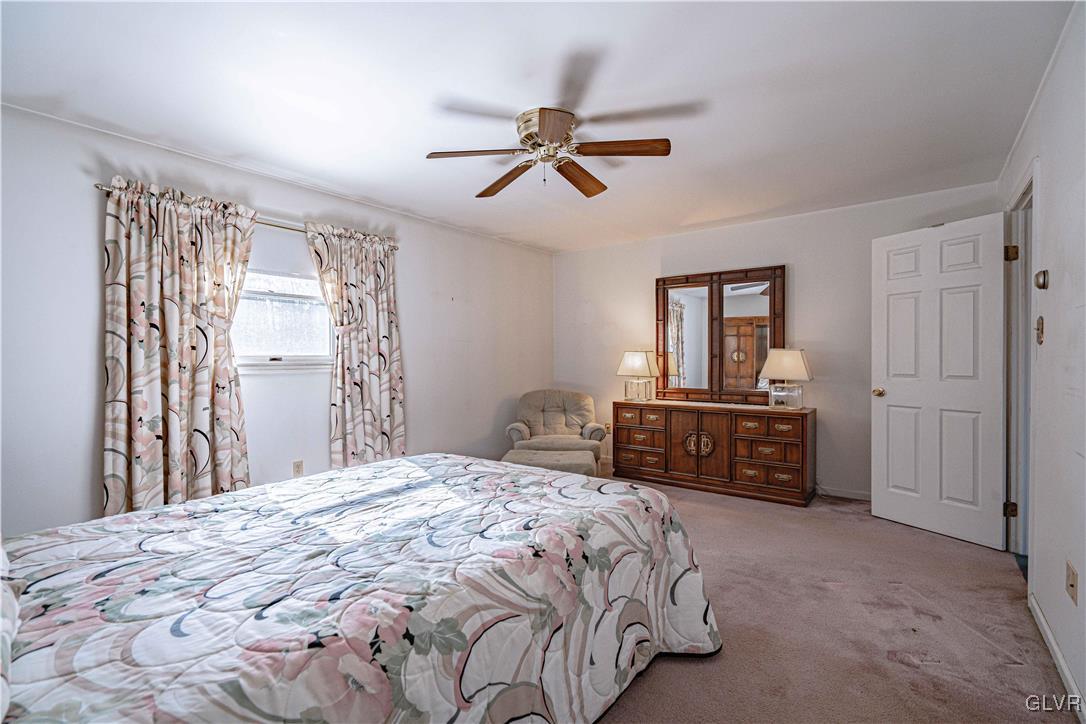 551 Birch Road Hazleton, PA 18202 - Photo 25 of 44 a bedroom with a bed and a chandelier