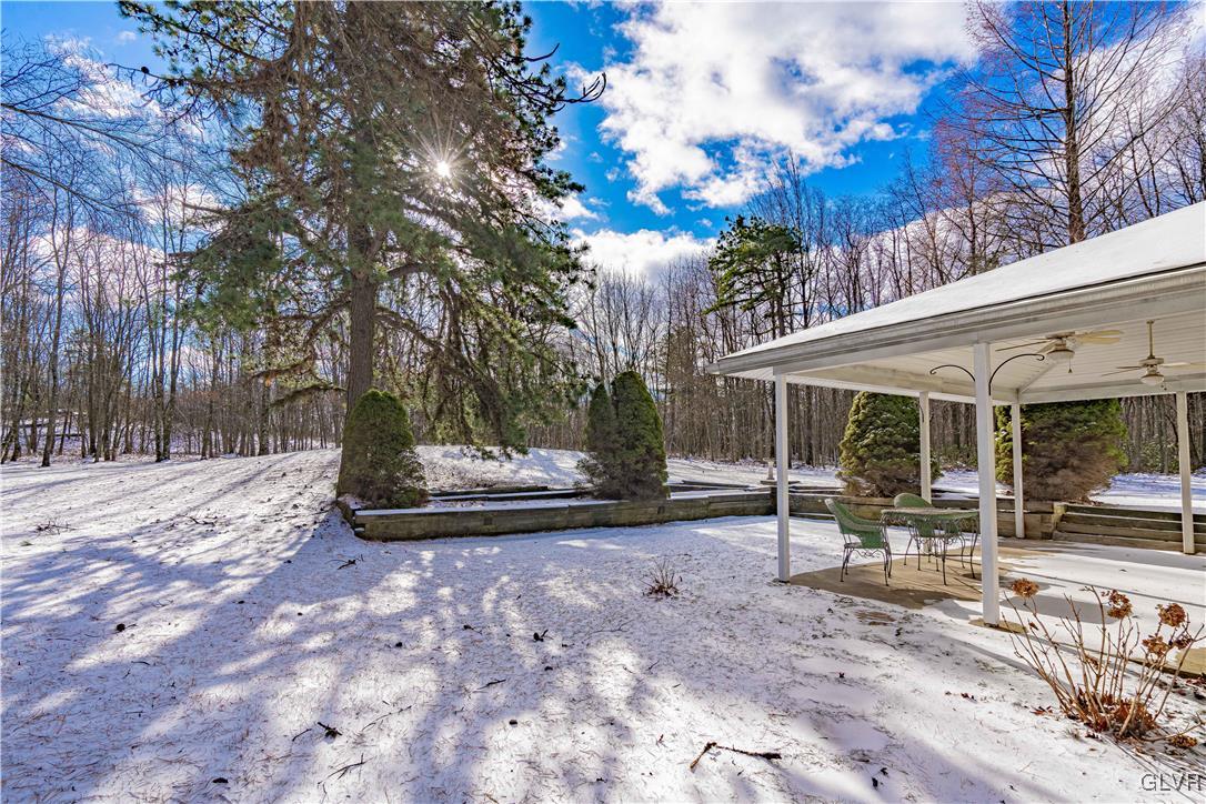 551 Birch Road Hazleton, PA 18202 - Photo 39 of 44 a view of a patio with a table and chairs under an umbrella