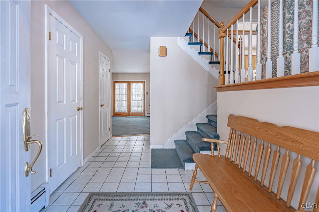 551 Birch Road Hazleton, PA 18202 - Photo 6 of 44 a view of staircase with lots of frames on wall and a potted plant